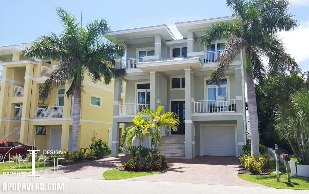 Modern coastal home with palm trees and bright exteriors in sunny climate. Unique architecture design.