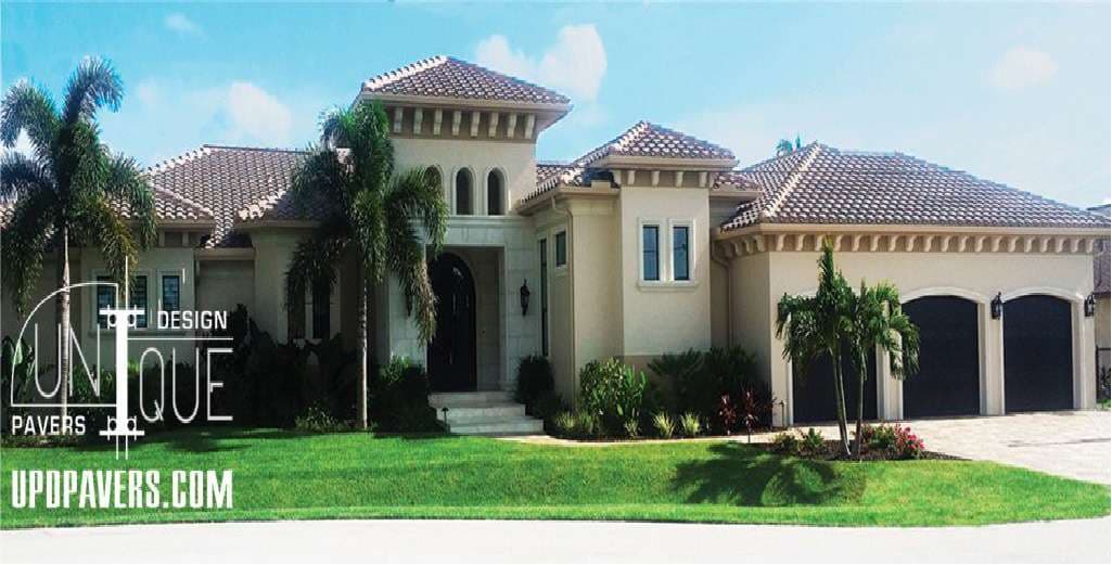 Luxury home with tropical landscaping and a tiled roof, showcasing elegant architectural design.