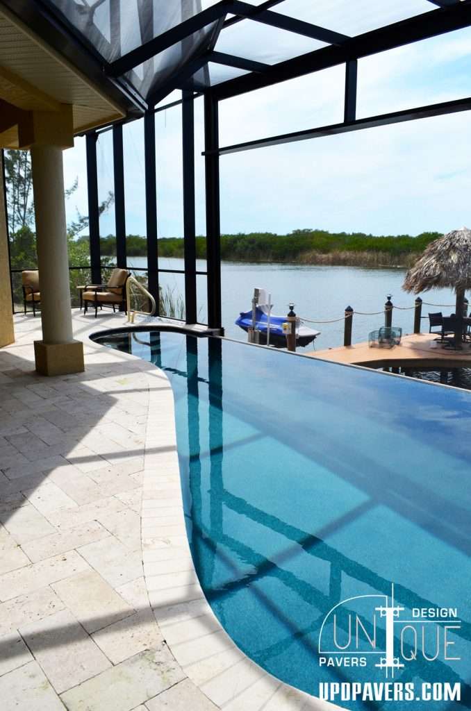 Luxury pool with a waterfront view and modern design in a tropical setting.
