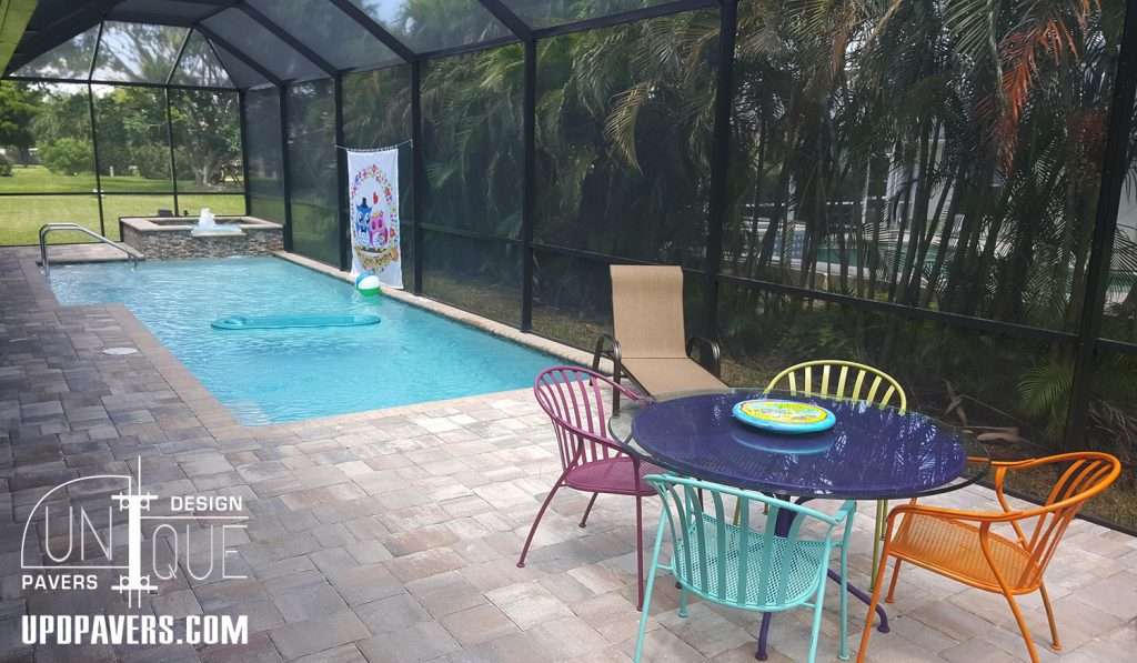 Backyard pool area featuring a modern design with colorful furniture and a swimming pool.