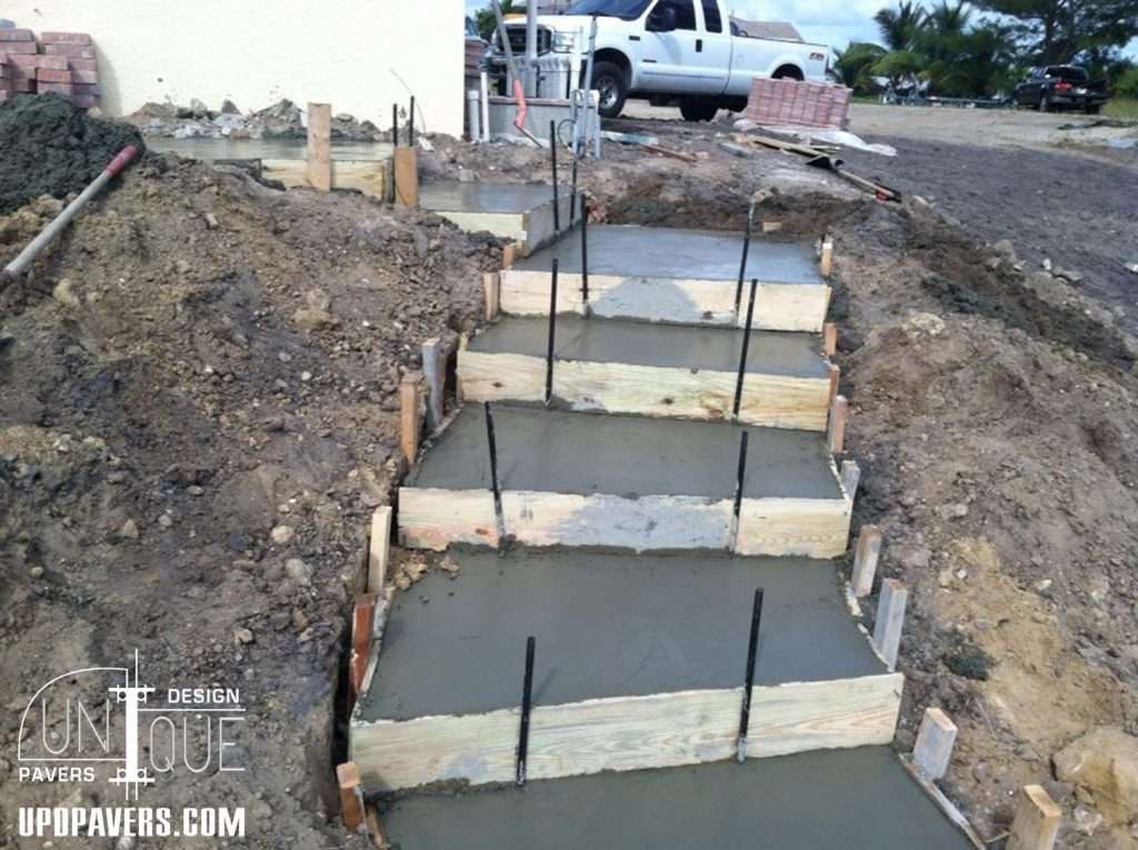 Concrete steps under construction with wooden forms and rebar for reinforcement.