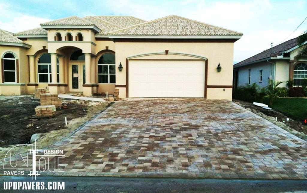 Modern home with paver driveway and stylish architecture, showcasing outdoor design elements.
