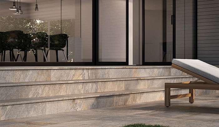 Modern outdoor area featuring stone steps, sliding glass doors, and patio furniture.
