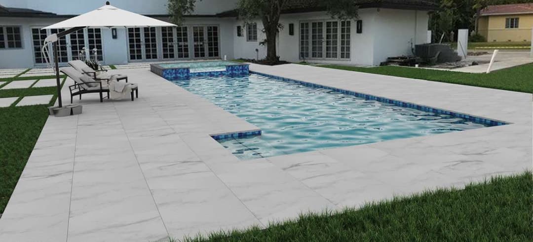 Modern backyard pool with lounge chairs, umbrella, and landscaped patio area.