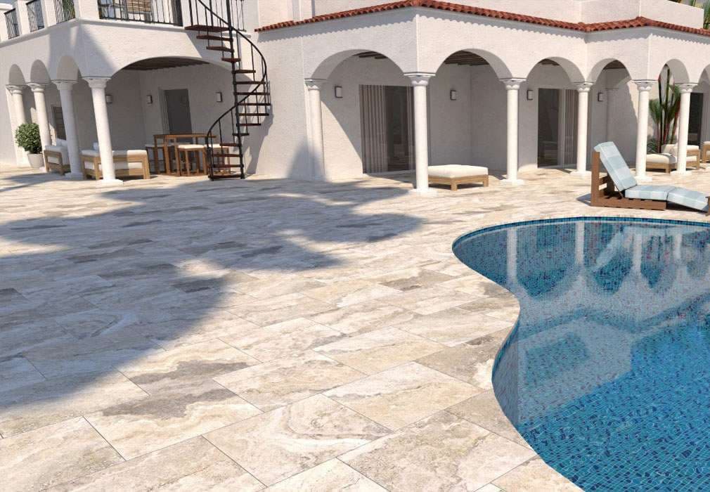 Luxury outdoor pool with stone patio, spiral staircase, and cozy seating area.